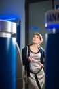 Pretty, young woman withdrawing money from her credit card