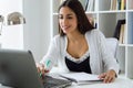 Pretty young woman working with laptop in her office. Royalty Free Stock Photo