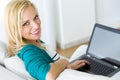 Pretty young woman working with laptop at home. Royalty Free Stock Photo