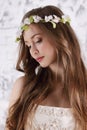 Pretty young woman in wreath with long hair looks down Royalty Free Stock Photo