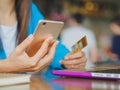 Pretty Young womans hands holding a credit card Royalty Free Stock Photo