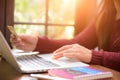 Pretty Young woman hands holding a credit card and using laptop Royalty Free Stock Photo