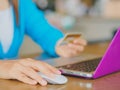 Pretty Young womans hands holding a credit card and using tablet, smartphone and laptop computer Royalty Free Stock Photo