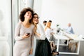 Pretty young women with moble phone in the office