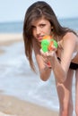 Pretty young women playing with water gun at the beach Royalty Free Stock Photo