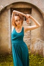 Pretty young women posing on ancient street