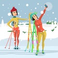 Pretty young women standing with skis and makes selfie