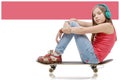 Pretty younggirl posing with a skateboard, seat on skate Royalty Free Stock Photo