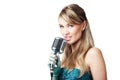 Pretty young girl singing into retro microphone Royalty Free Stock Photo