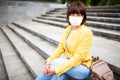 Pretty youthful middle-aged woman in white medical mask