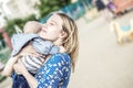 Prettyl happy mather with baby boy Embracing him emotionally on a liking Royalty Free Stock Photo