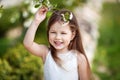 Prettyl smiling little girl in cream dressin the blossom garden Royalty Free Stock Photo