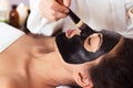 Prettyl woman with facial mask at beauty salon. Spa treatment Royalty Free Stock Photo