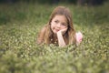 Prety young girl laying in spring flowers Royalty Free Stock Photo
