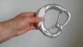 Pretzel from cast aluminium in reached out hand