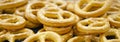 Pretzel with many small cookies scattered on a dark background. Traditional food for Oktoberfest - salt appetizer pretzels on a