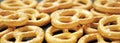 Pretzel with many small cookies scattered on a dark background. Traditional food for Oktoberfest - salt appetizer pretzels on a