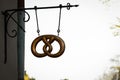 Pretzel signboard on white sky background. Bakery, cafe or pastry shop emblem sign with wrought iron in medieval style Royalty Free Stock Photo