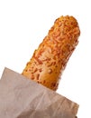 pretzel stick with cheese in paper bag isolated on a white background. Fast food backed