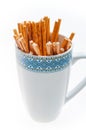 Pretzel sticks in a cup on white background Royalty Free Stock Photo