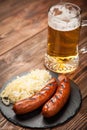 Pretzels, bratwurst and sauerkraut on wooden table