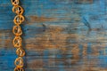 Pretzels hanging on a rope on rustic wooden background