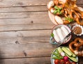 Pretzels, white bavarian sausages, beer and vegetables on old wooden background, german traditional food, oktoberfest Royalty Free Stock Photo