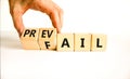 Prevail or fail symbol. Concept words Prevail or Fail on wooden cubes. Businessman hand. Beautiful white table white background.