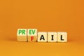 Prevail or fail symbol. Concept words Prevail or Fail on wooden cubes. Beautiful orange table orange background. Business prevail