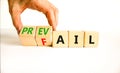 Prevail or fail symbol. Concept words Prevail or Fail on wooden cubes. Businessman hand. Beautiful white table white background.