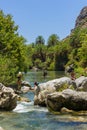 PREVELI, CRETE - JULY 21 2021: Crowds of people exploring the natural palm forest and sandy beach at Preveli on the southern coast Royalty Free Stock Photo