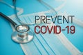 Prevent COVID-19 inscription on face mask and stethoscope background.