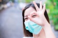 Prevent spread of coronavirus and PM2.5 toxic dust, air pollution problem. Head shot of woman wearing green medical face mask. Royalty Free Stock Photo