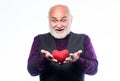 Preventing heart attack. Heart problem and healthcare. Senior bald head bearded man hold red heart. Mature man with