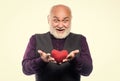 Preventing heart attack. Heart problem and healthcare. Senior bald head bearded man hold red heart. Mature man with