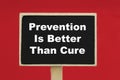 Prevention Is Better Than Cure on a chalkboard against red background