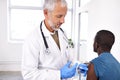 Prevention is better than cure. a mature male doctor giving his patient an injection. Royalty Free Stock Photo