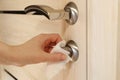 Woman clean home doors handle, antibacterial wet wipe, corona virus protection.