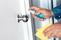 Prevention concepts on coronavirus  covid-19  outbreak situation with person cleaning doorknob by alcohol.body health care Royalty Free Stock Photo