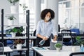 Prevention of coronavirus. African american millennial girl in protective mask disinfects laptop Royalty Free Stock Photo