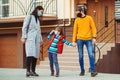 Prevention coronavirus. Young family wearing protection face mask outdoors. Coronavirus quarantine