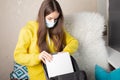 Prevention of diseases in schools, colleges, universities, a student in a medical mask puts textbooks and notebooks in a backpack