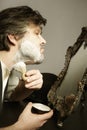 Shaving of man`s face in prewar style with razor and brush Royalty Free Stock Photo
