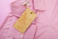 Price tag hang over pink shirt close up view - Image Royalty Free Stock Photo