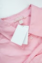 Price tag hang over pink shirt close up view - Image Royalty Free Stock Photo