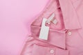 Price tag hang over pink shirt close up view - Image Royalty Free Stock Photo