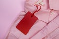 Price tag hang over pink shirt close up view - Image Royalty Free Stock Photo