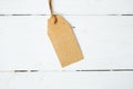 price tag label on wooden background One paper blank tags with rope on wooden background. Royalty Free Stock Photo