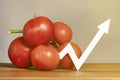 The price of tomatoes and vegetables. Rising prices for tomatoes. Fresh red ripe tomatoes with twigs on the table