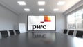 PricewaterhouseCoopers PwC logo on the screen in a meeting room. Editorial 3D rendering